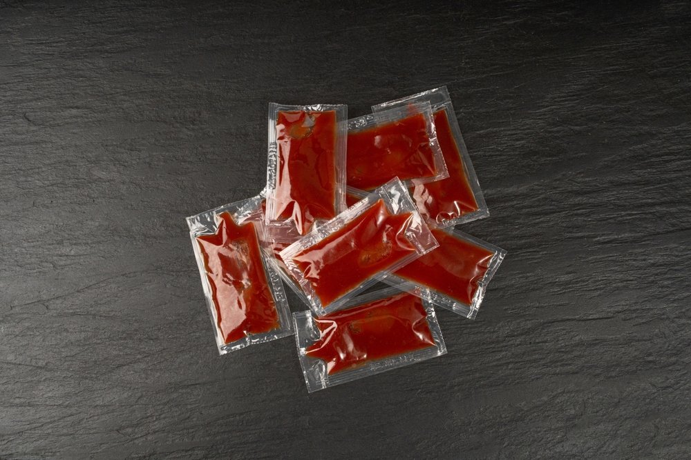 Packets of sauce sealed with a vacuum packaging machine.